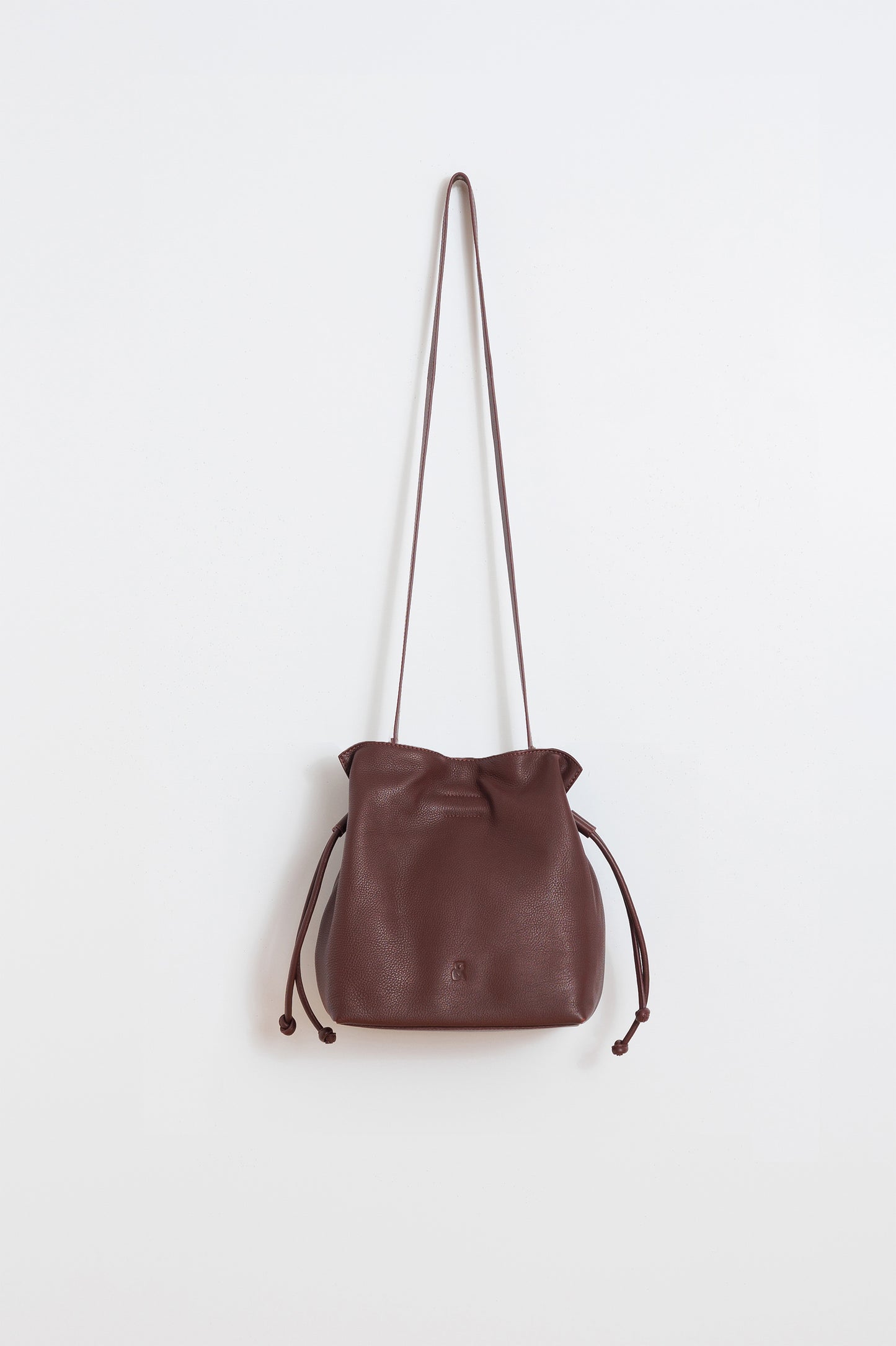 RUCHED-LEATHER SLING BAG